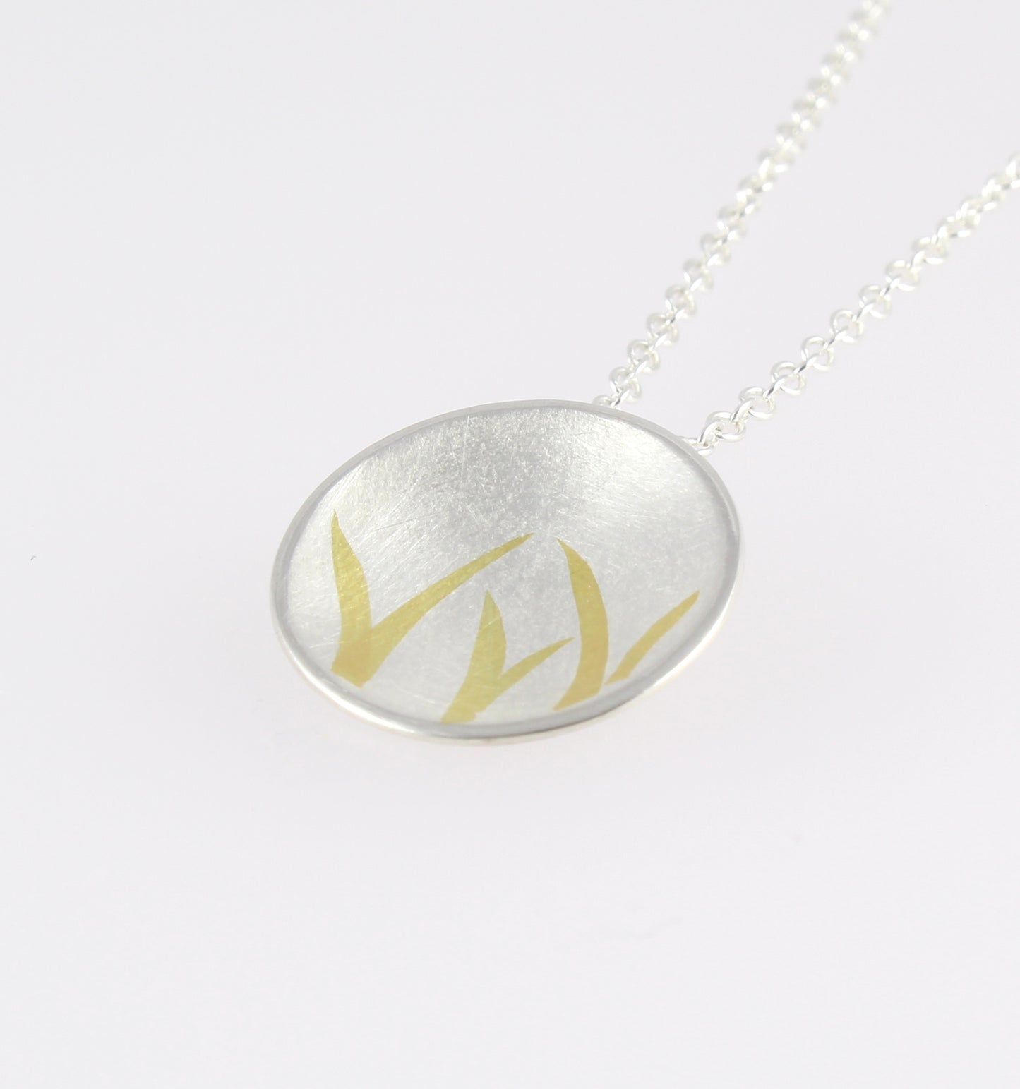 Domed Silver Pendant with gold detail