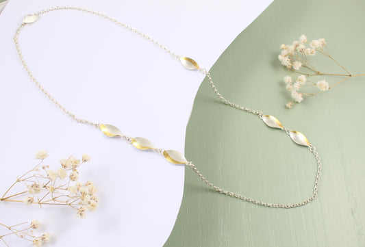 Long curved silver and gold necklace