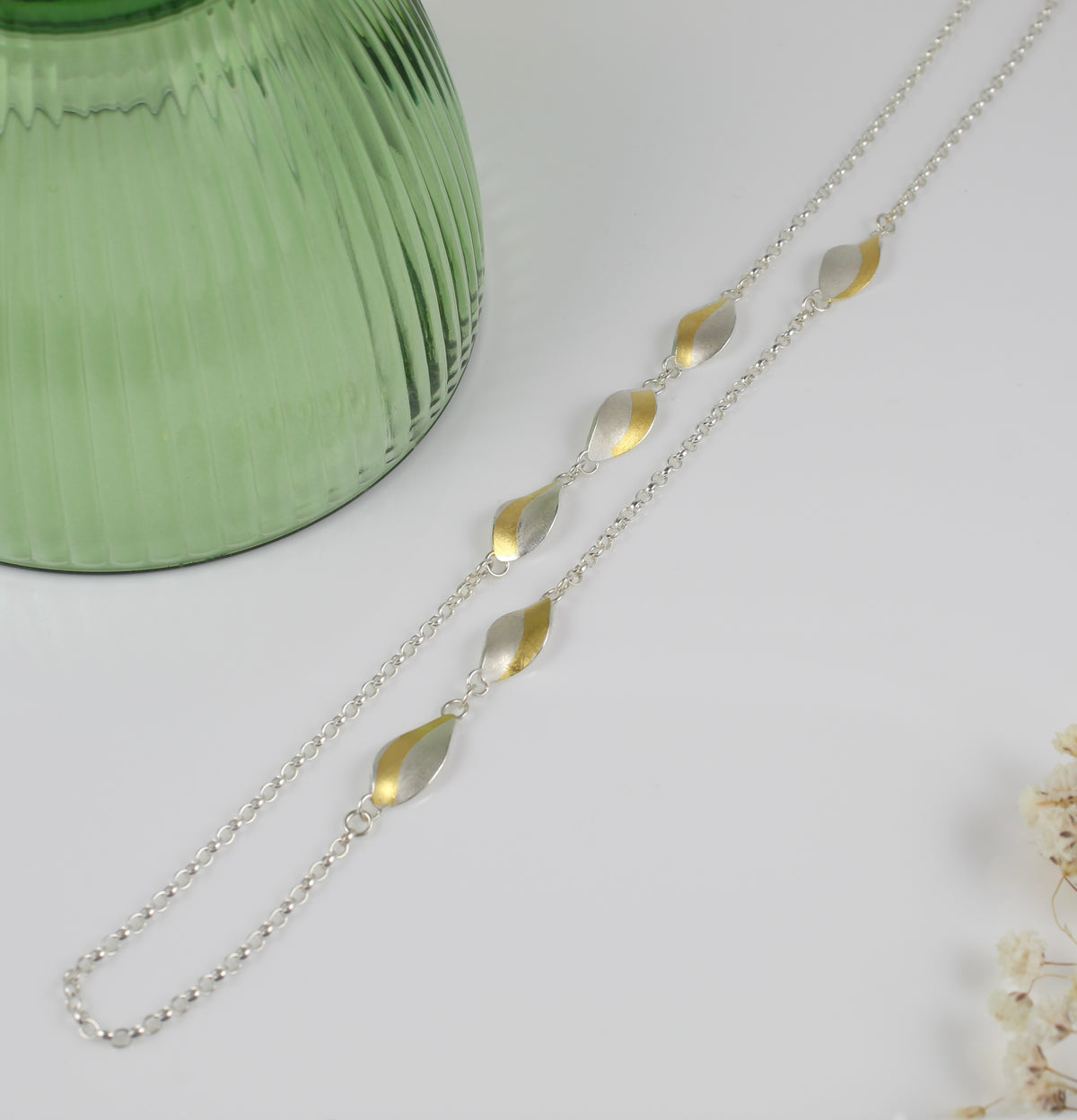 Long curved silver and gold necklace